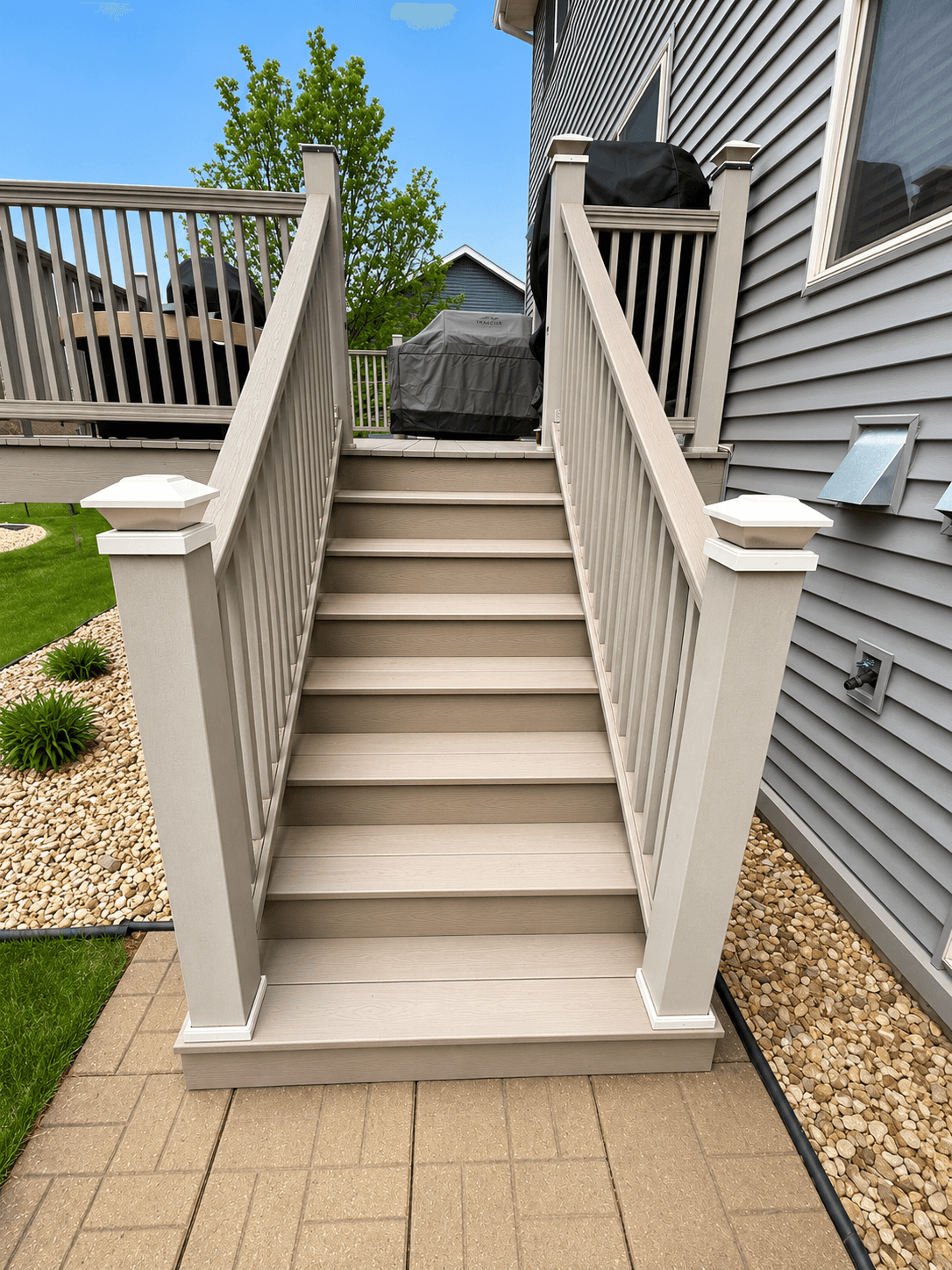 Composite deck stairs with matching railings by All-Pro Decks and Patios