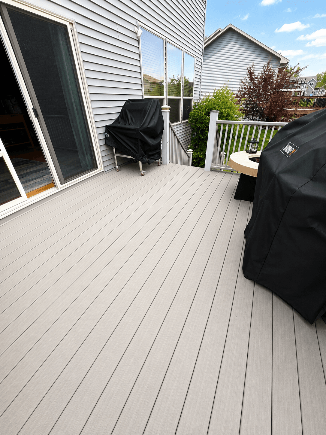 Finished composite deck surface with outdoor grilling space